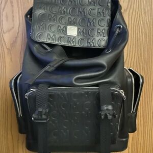 MCM Black Backpack with Monogram Pattern and Structured Design